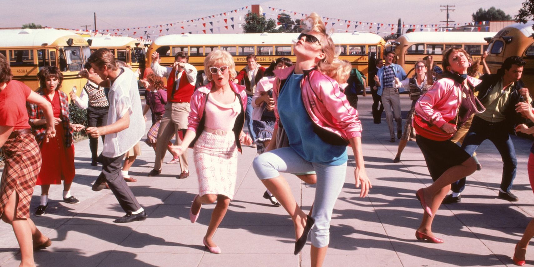 Steph and students dancing gin front of school in Grease 2