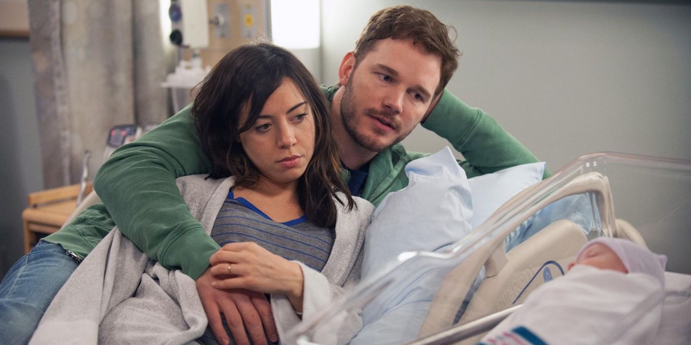 April and Andy looking at their newborn
