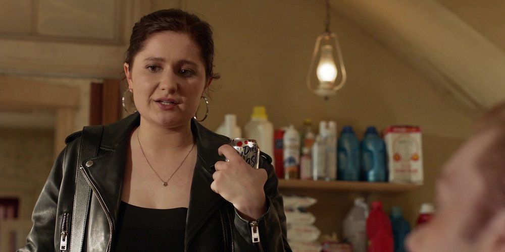 Debbie wears leather jacket and holds soda in Shameless