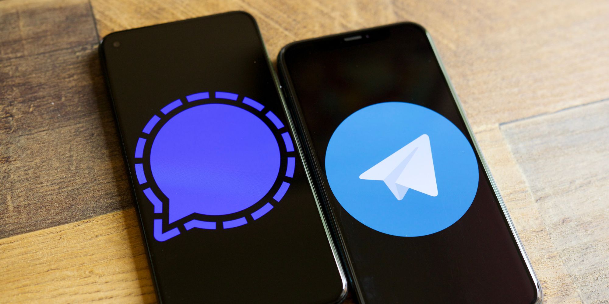 Signal and Telegram logos on two smartphones