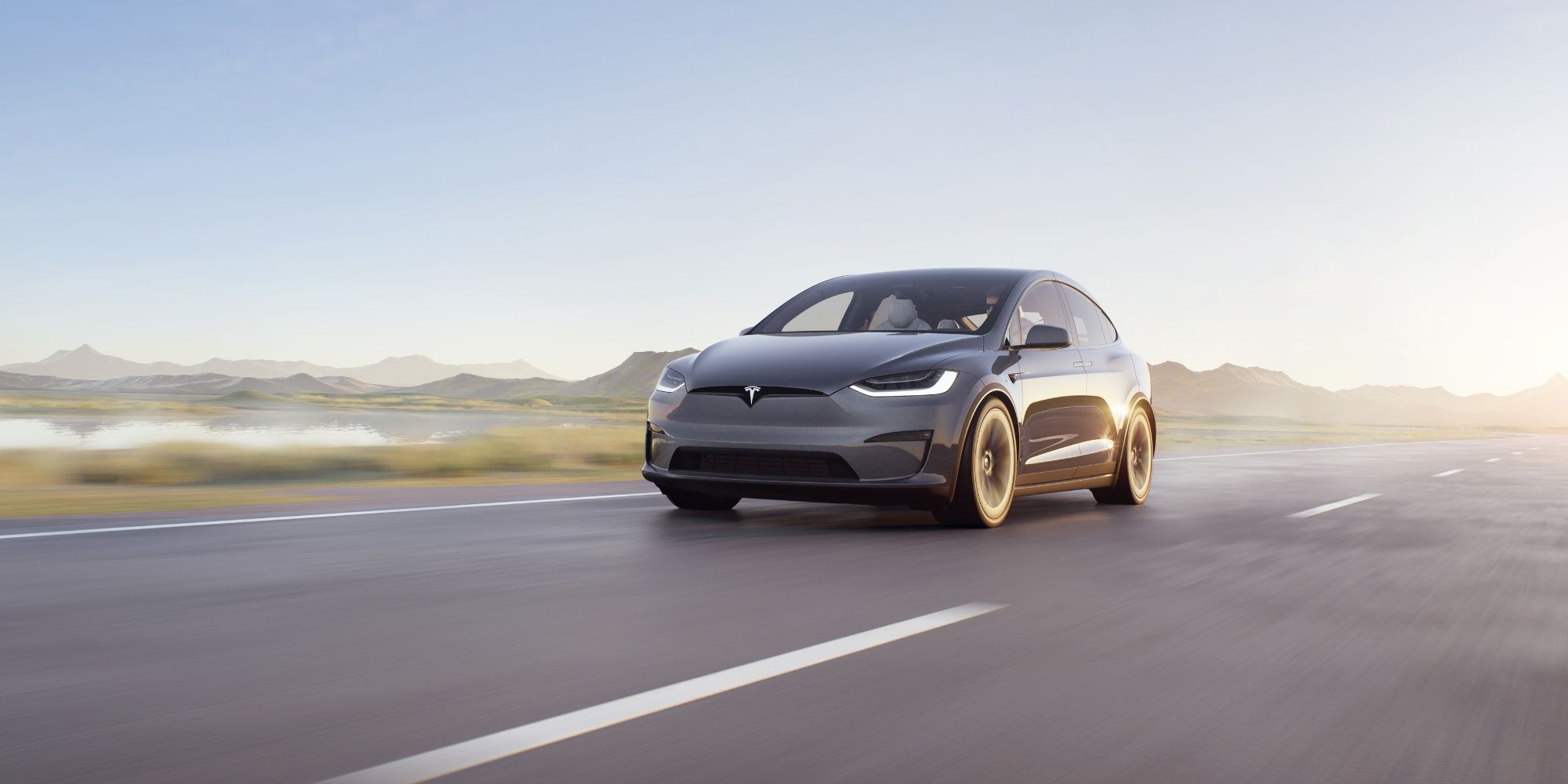 Gray Tesla Model X driving on a road