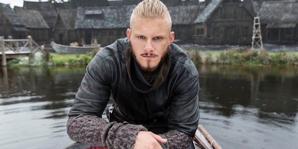 Bjorn squats on boat in Vikings
