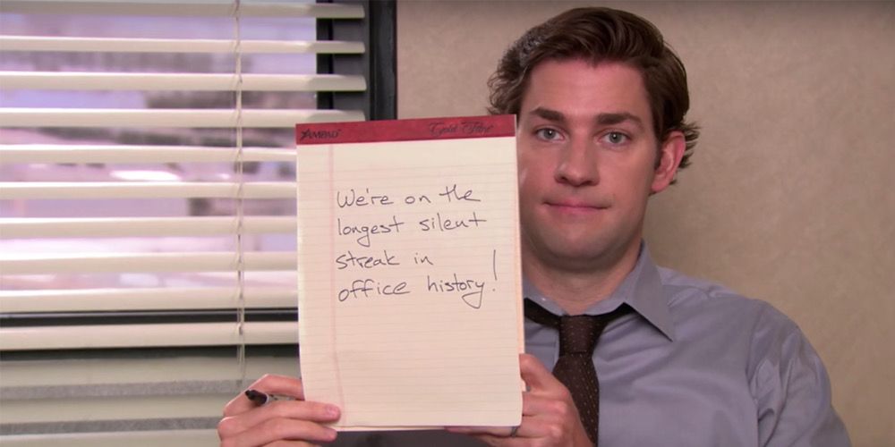 Jim holds up a notepad instead of talking in The Office