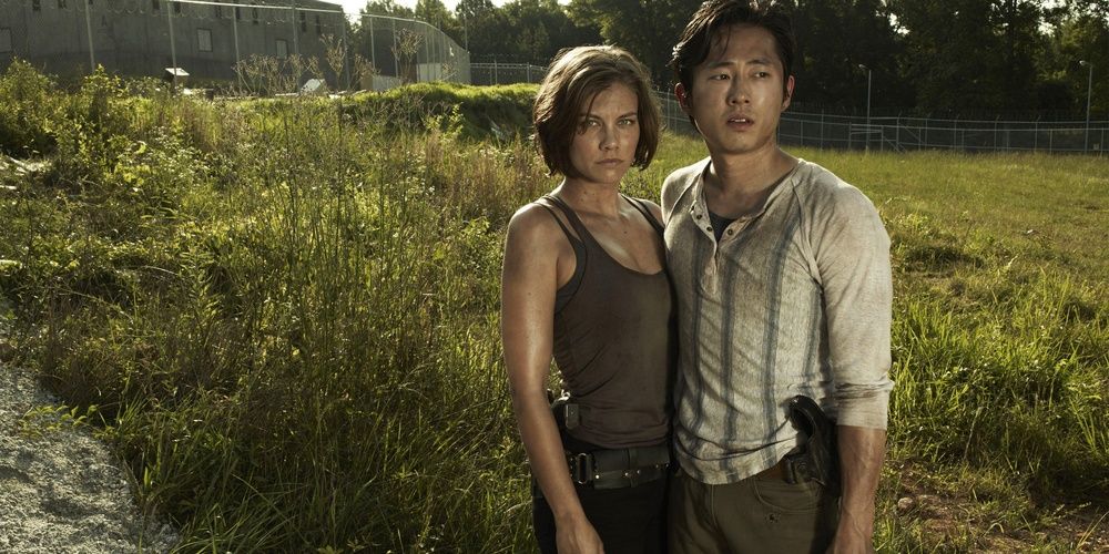 Glenn and Maggie stand in a field in The Walking Dead