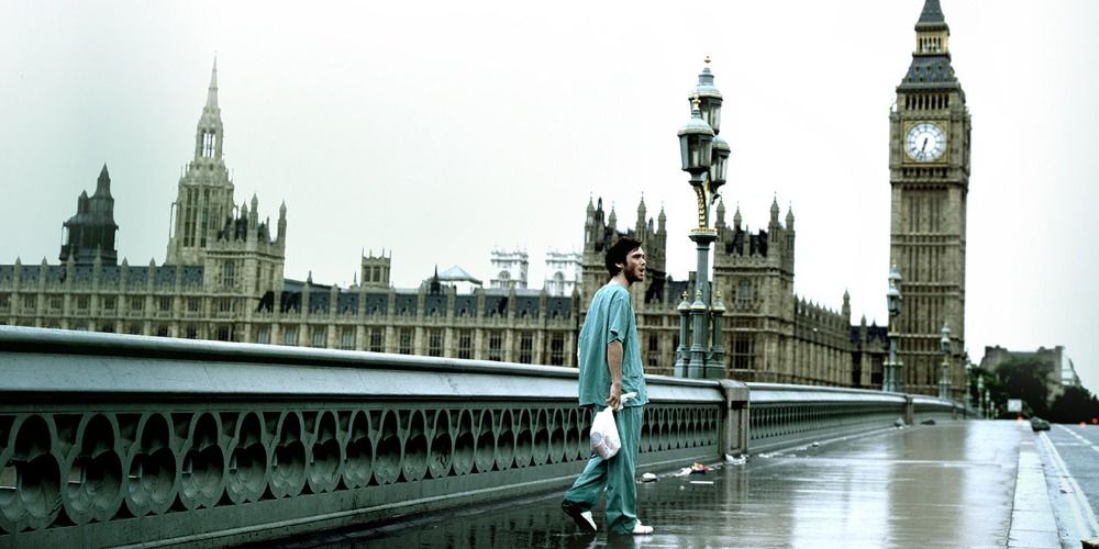 Jim holding a plastic bag and roaming an empty street in a scene from 28 Days Later
