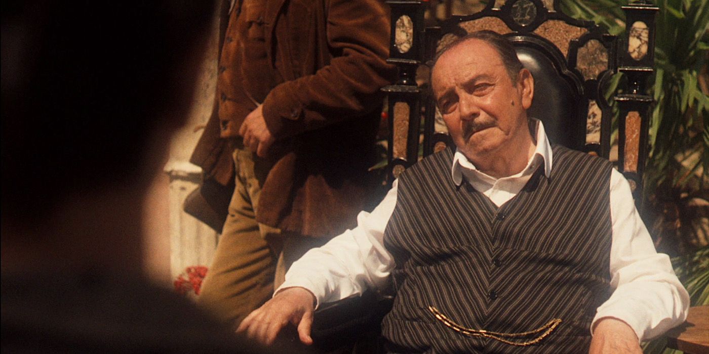 Francesco Ciccio sits outside and speaks with Vito in The Godfather Part II