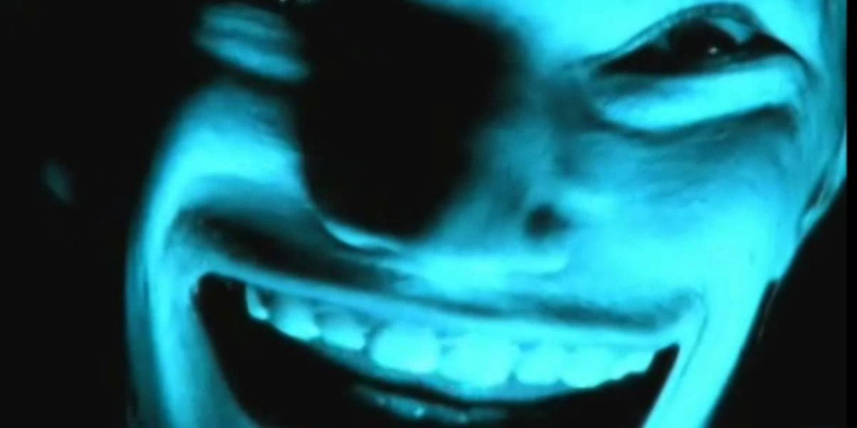 A distorted face on the TV screen in a still from Come To Dadd by Aphex Twin.
