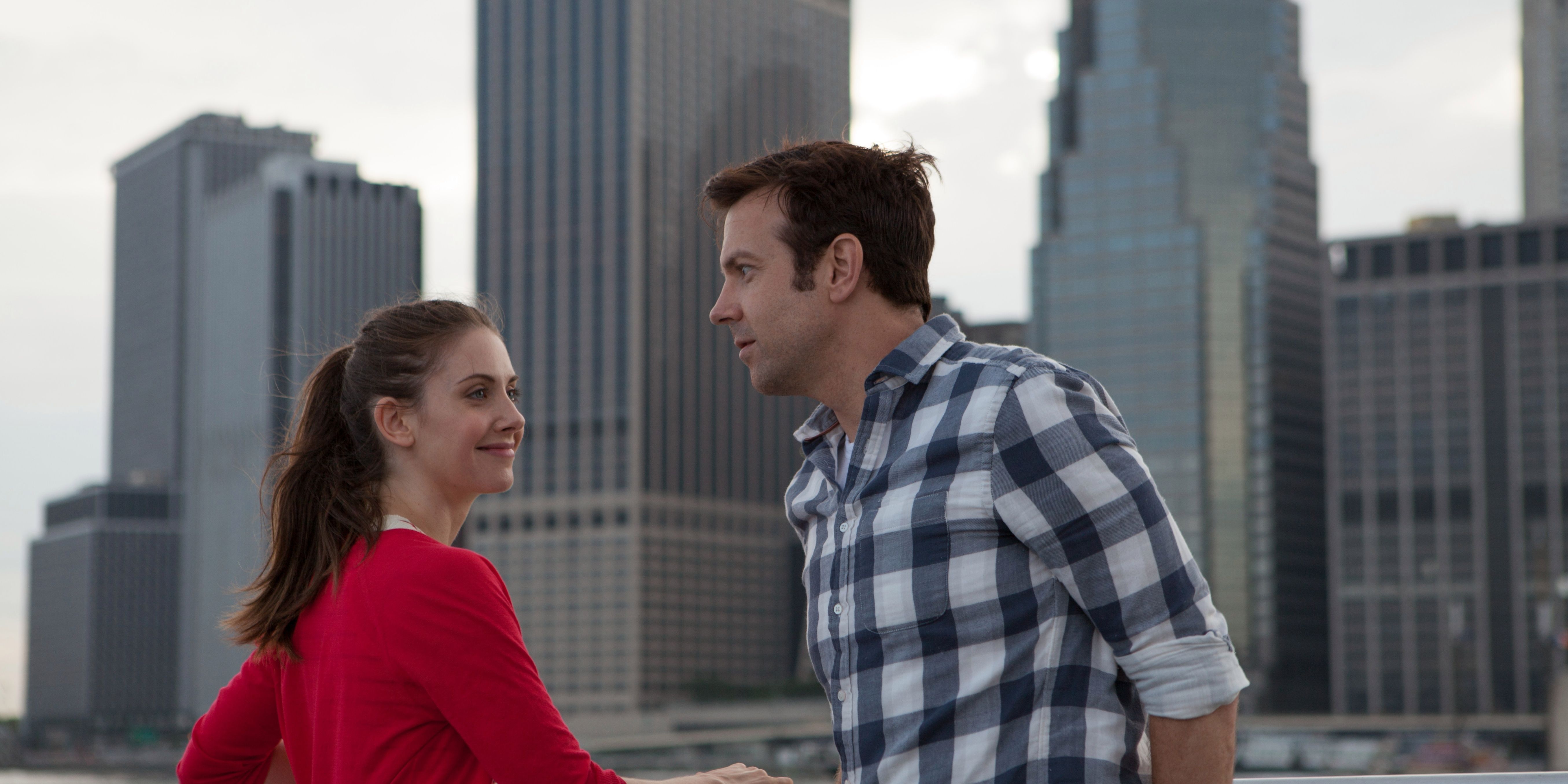 Alison Brie and Jason Sudeikis in Sleeping With Other People standing with the city in background