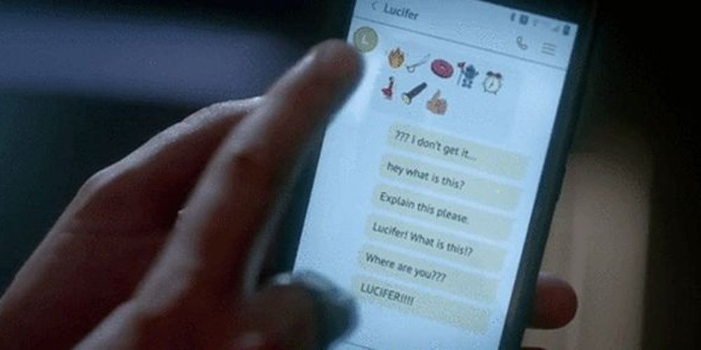 Amenadiel looks at his phone with emojis 
