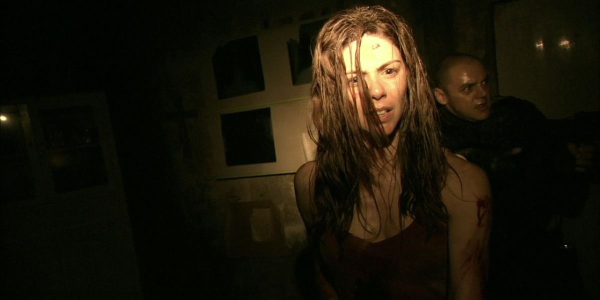 A young woman cries in the dark in REC 2