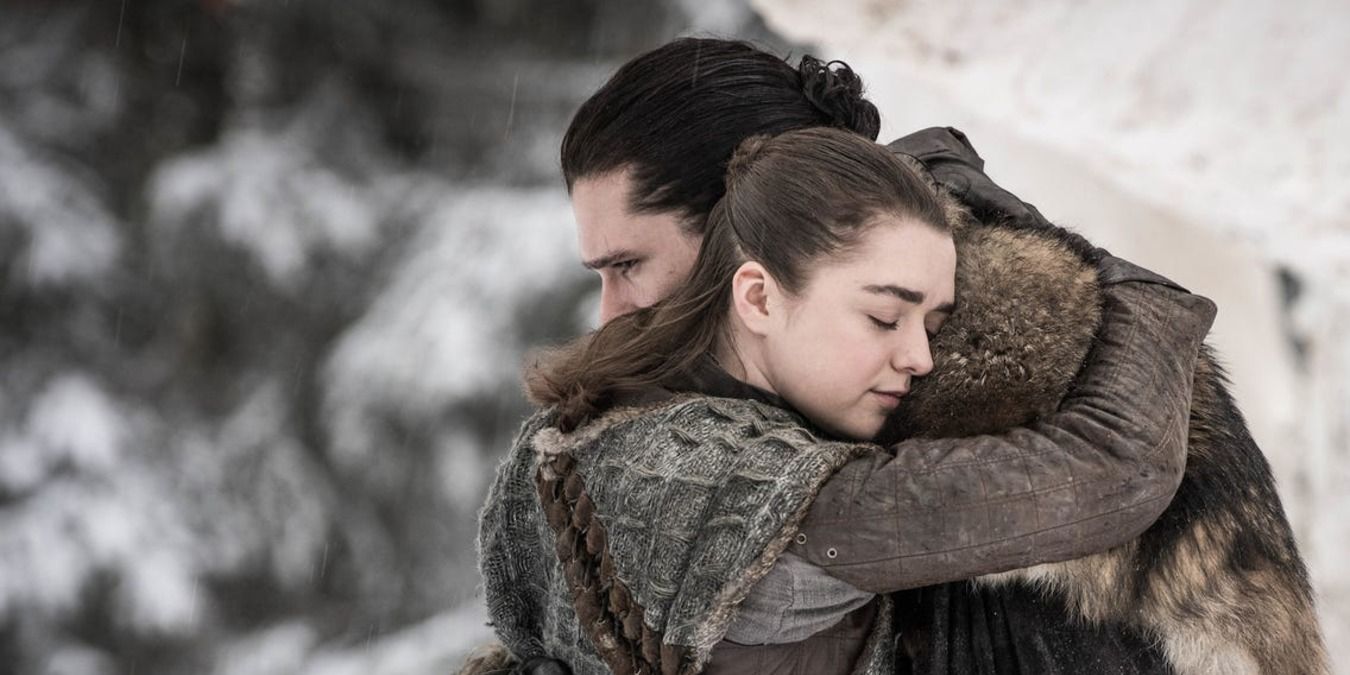 Arya and Jon hugging in the snow in Game of Thrones.