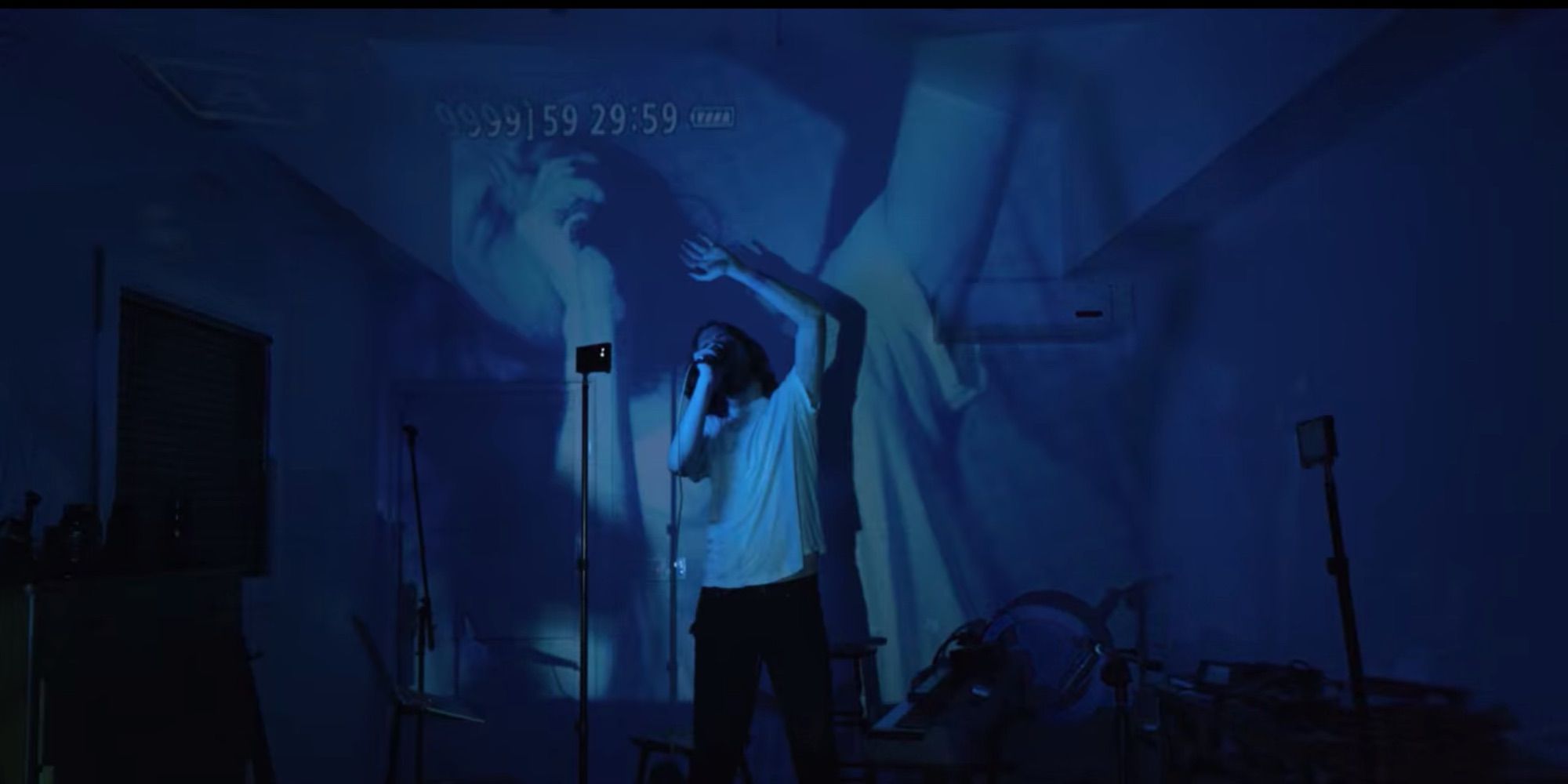 Bo Burnham performing against a projection of himself