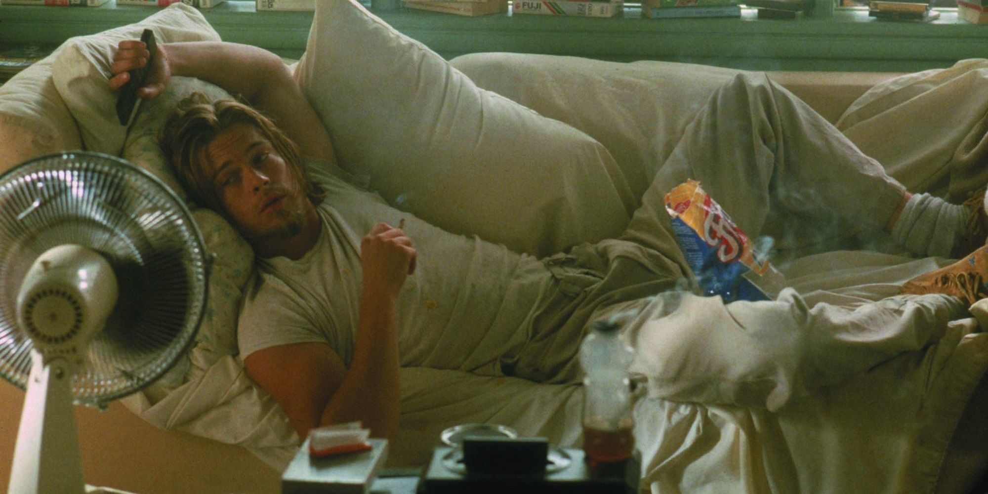 Brad Pitt as Floyd lying on a couch in True Romance