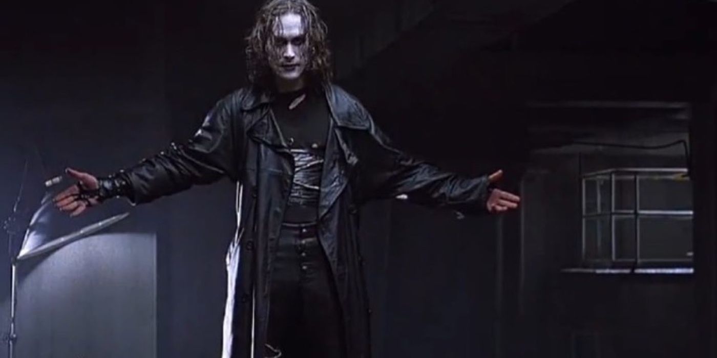 Brandon Lee holding his arms out as The Crow.