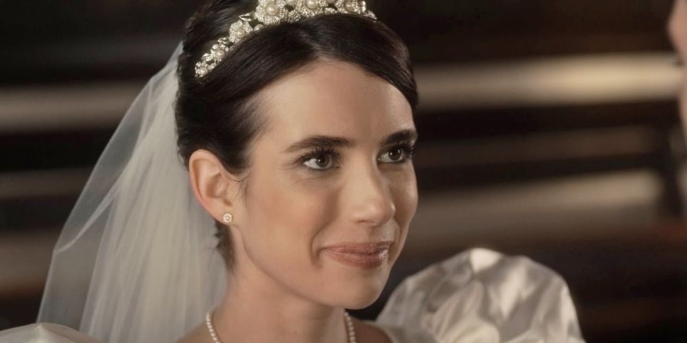 Brooke smiling in a wedding gown in a scene from AHS 1984