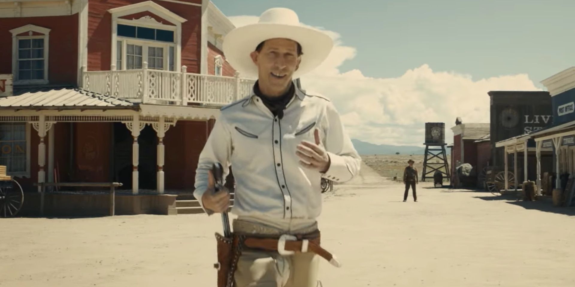 Tim Blake Nelson as Buster Scruggs holsters a pistol in The Ballad of Buster Scruggs