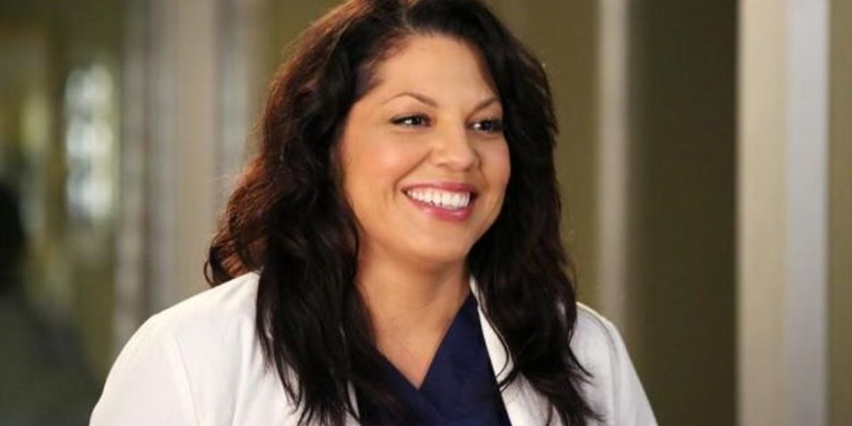 Callie Torres smiling at someone at work in Grey's Anatomy