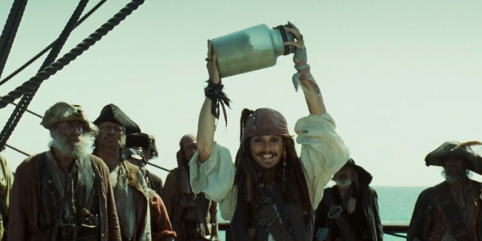 Captain Jack Sparrow holds up his jar of dirt in Pirates of the Caribbean