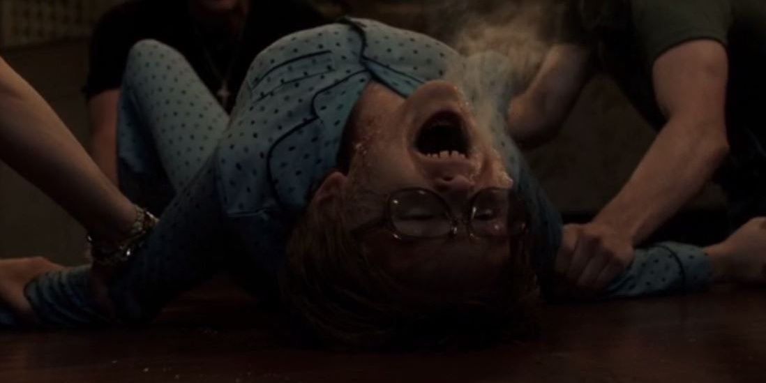 David screams on a table while foaming from the mouth in The Conjuring The Devil Made Me Do It