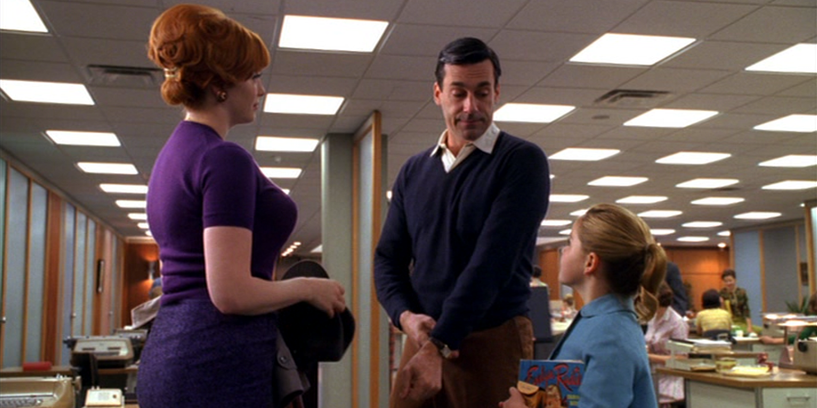 Don Draper with Sally talking to Joan in Mad Men.