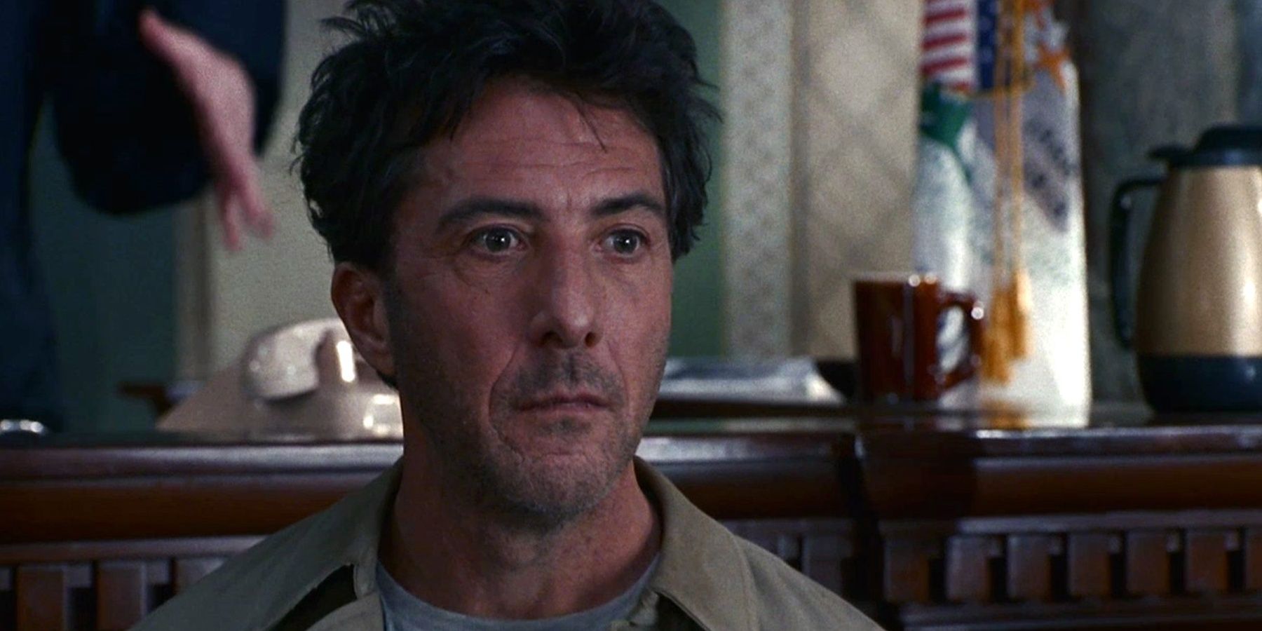 Dustin Hoffman looking sad and standing in courtroom