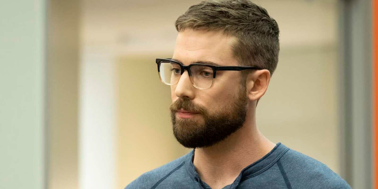 Josh listens intently in a meeting room.