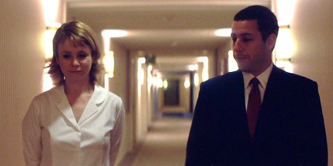 Barry and Lena walk down a hallway together in Punch Drunk Love