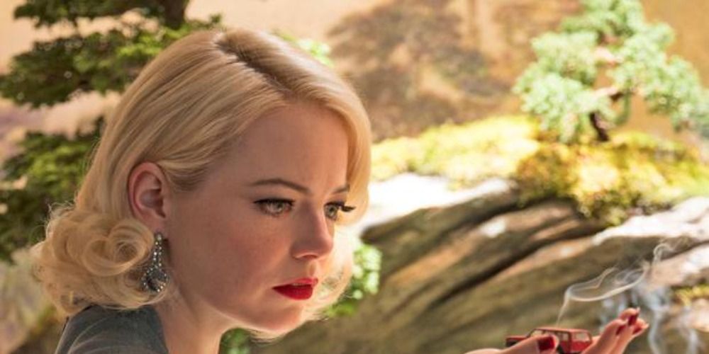 Emma Stone in Maniac looking at a toy car with smoke coming out of it