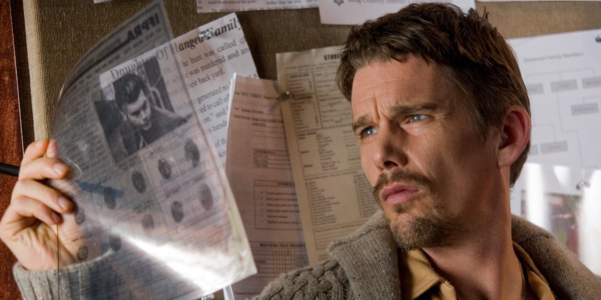 Ethan Hawke looking at a piece of paper in Sinister