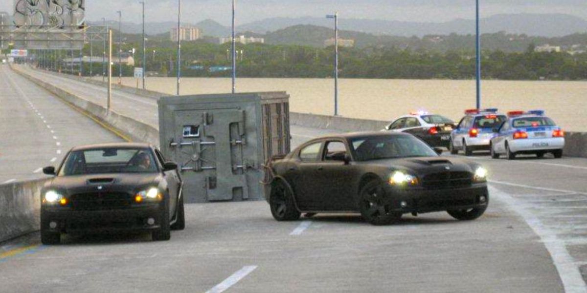 Dom and Brian dragging large metal vault with their cars in Fast Five