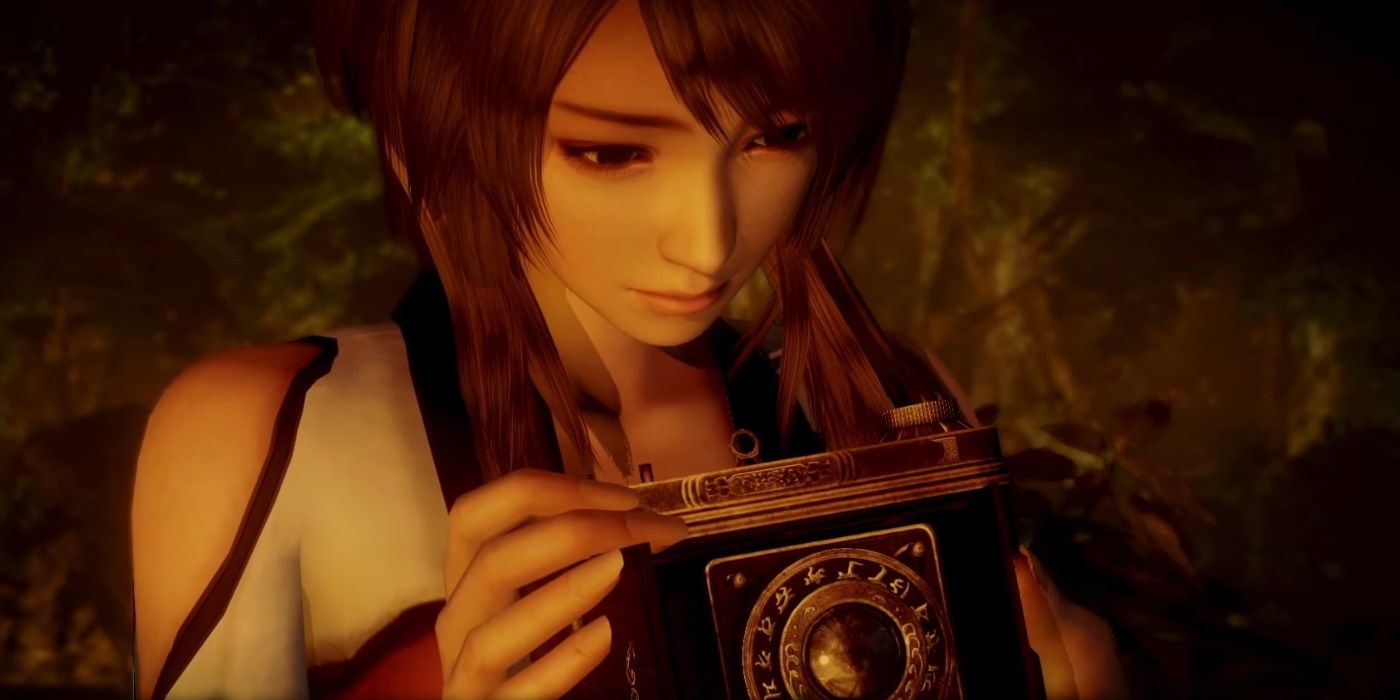 Woman looking down at camera concerned in a screenshot from Fatal Frame: Maiden of Black Water.