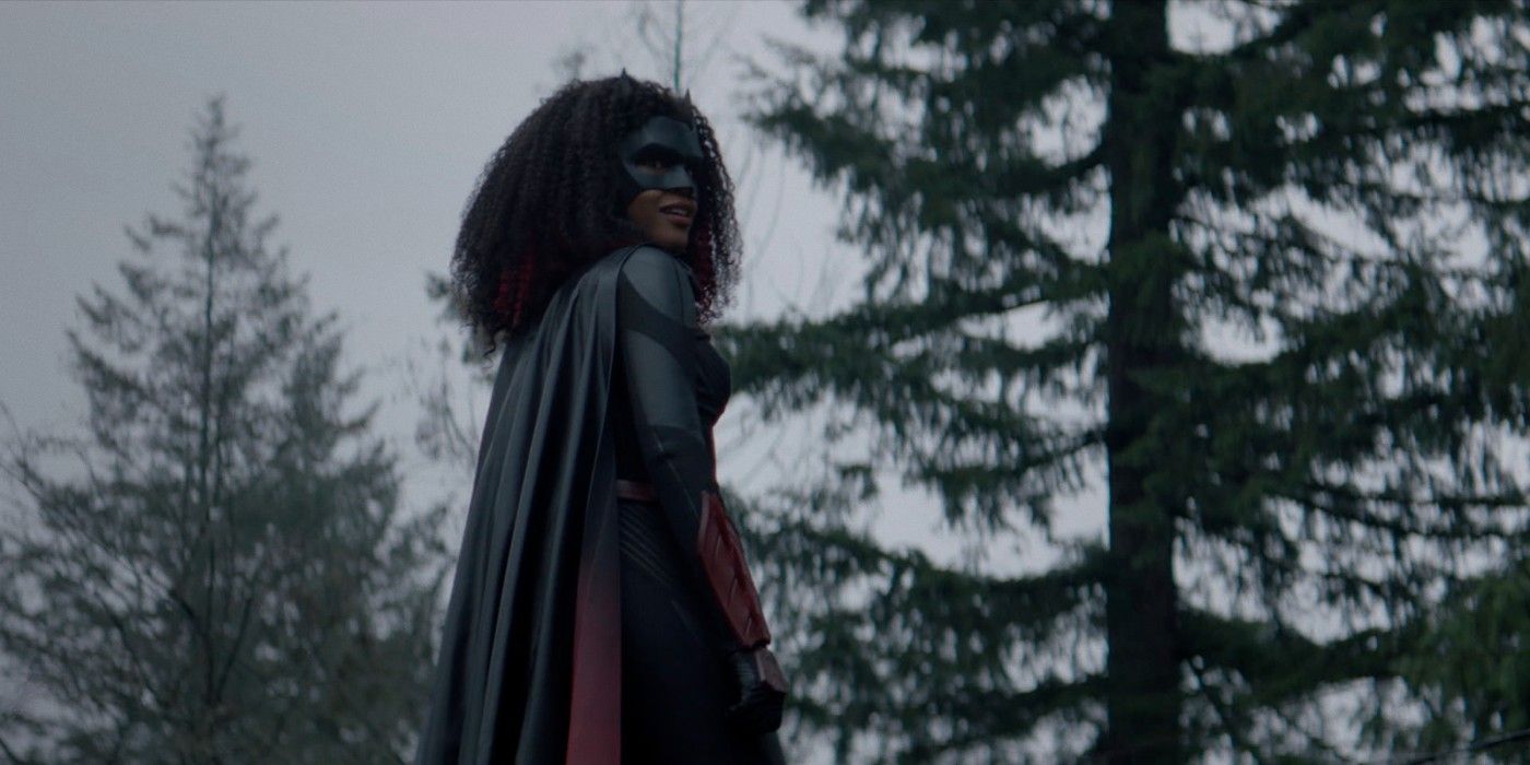 Batwoman: standing in the middle of the forest , wearing her suit