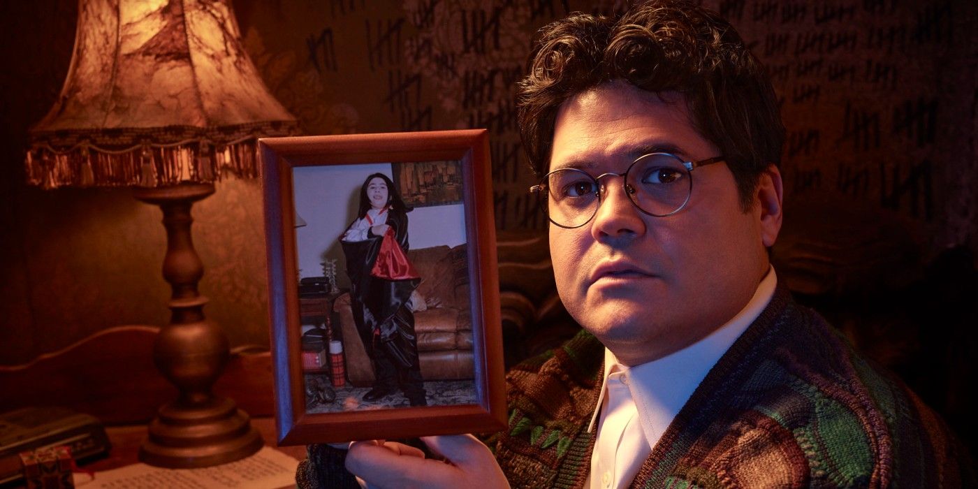 Guillermo holding a photo of himself in What We Do in the Shadows.