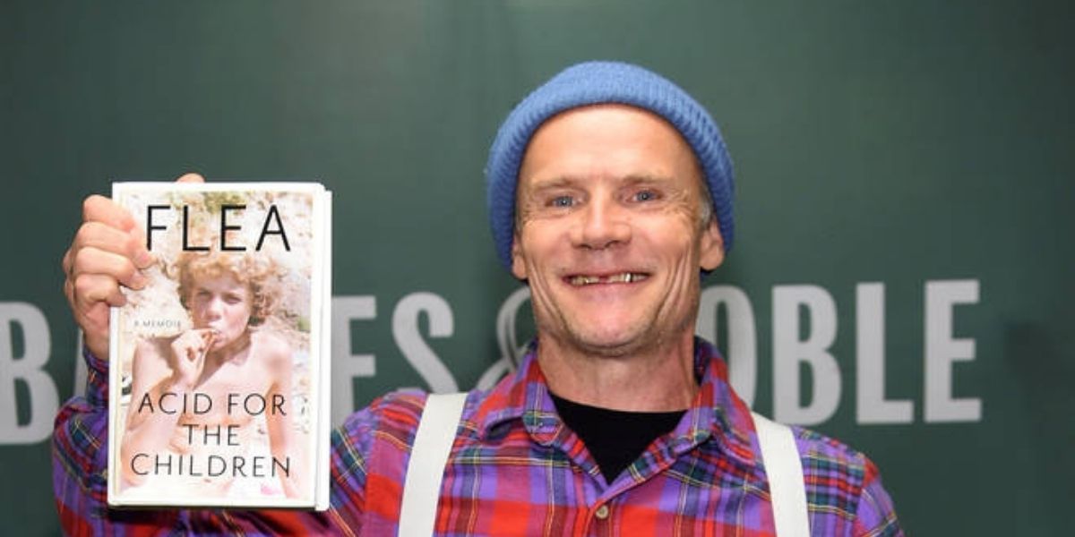 Flea posing with his memoir, Acid for the Children