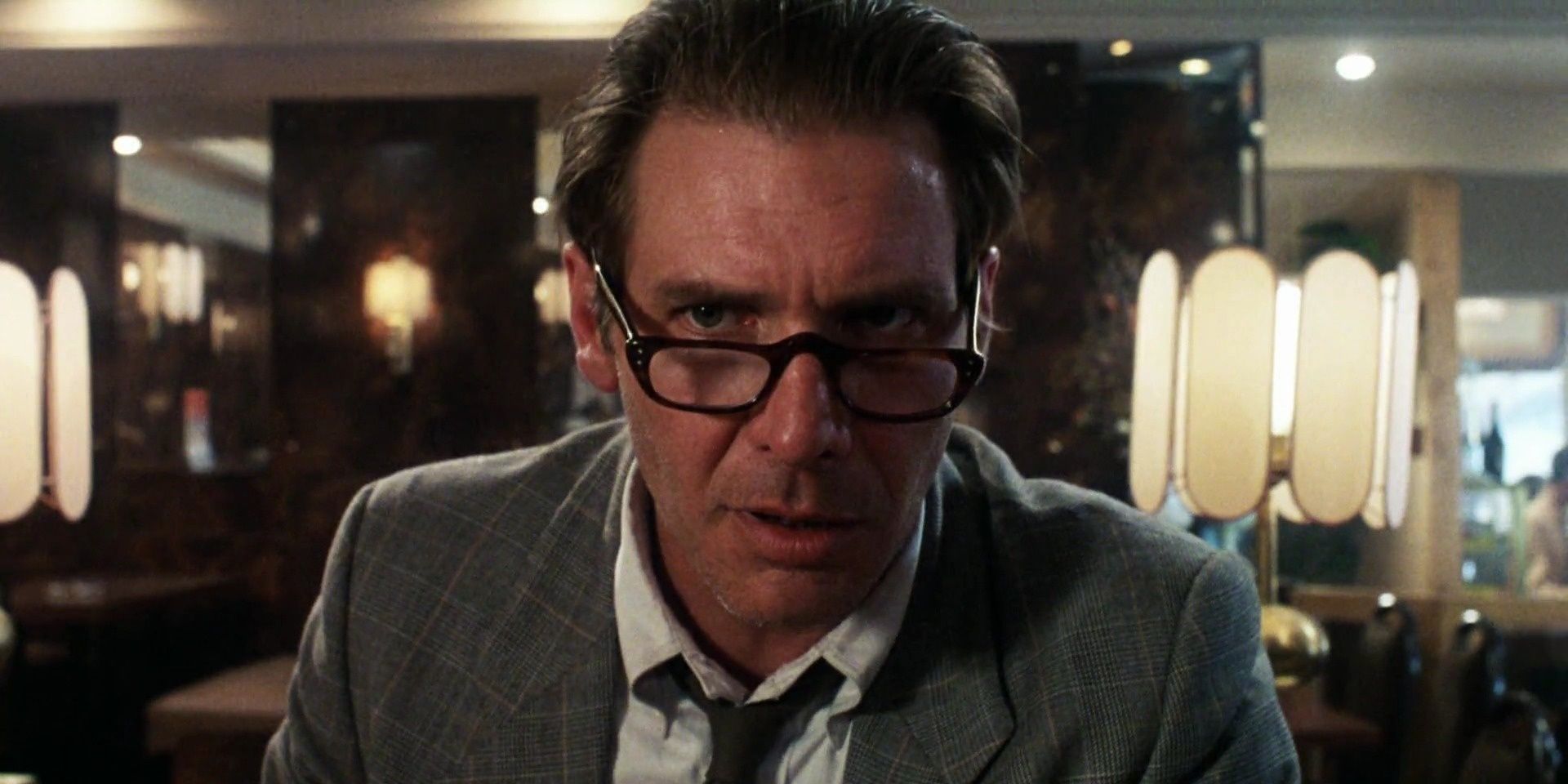 A close-up of a man looking nervous in the movie Frantic