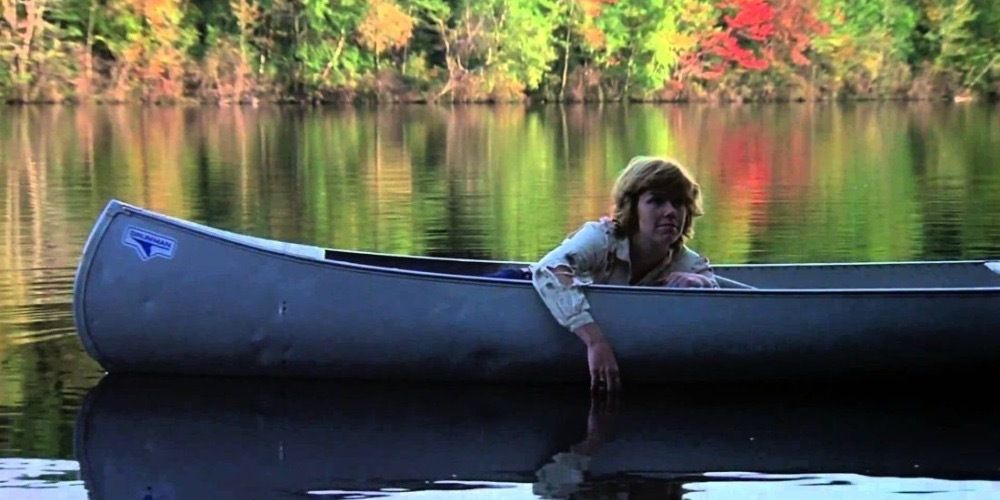 A woman on a canoe in the middle on a lake in Friday the 13th