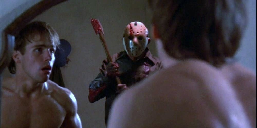 A young man sees Jason on the mirror