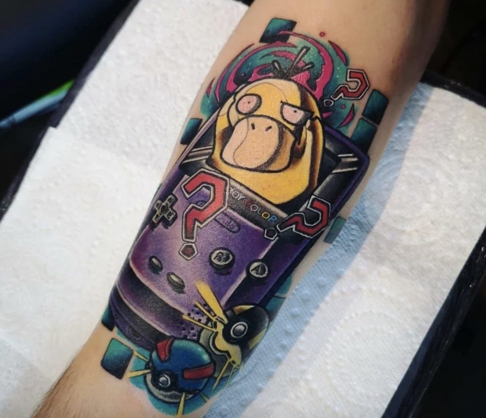 Tattoo of Psyduck coming out of the screen of a GameBoy color