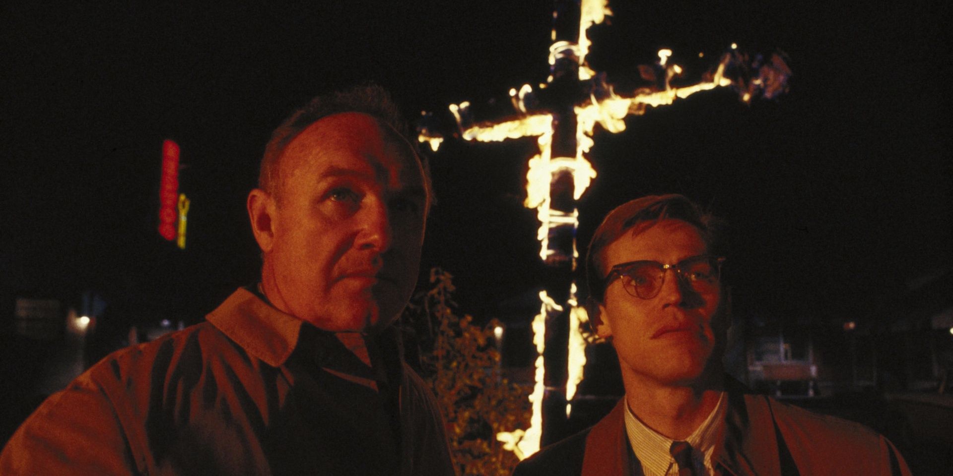 Gene Hackman and Willem Dafoe in the film Mississippi Burning standing in front of a burning cross