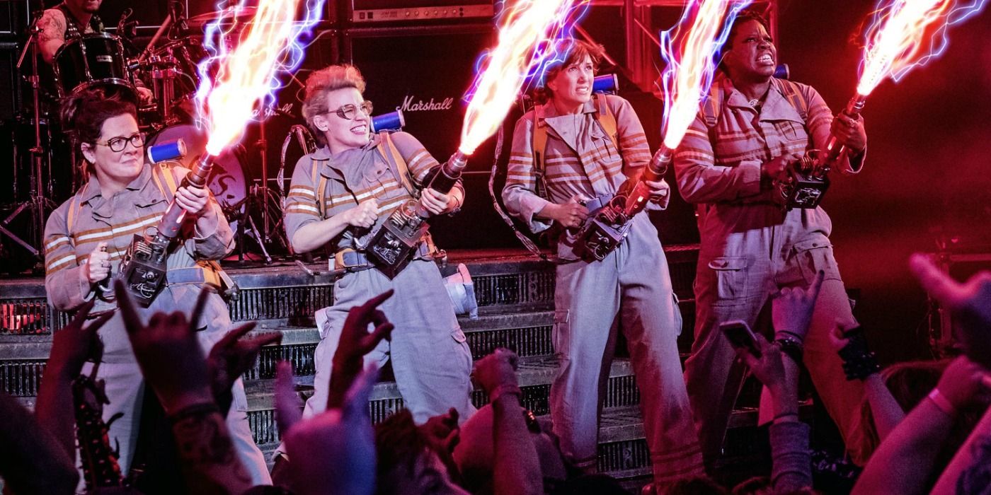 The four ghostbusters firing their proton packs in 2016 reboot