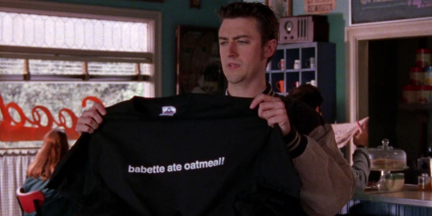 Kirk holding up a t-shirt that says &quot;Babette ate oatmeal&quot; in Luke's diner on Gilmore Girls