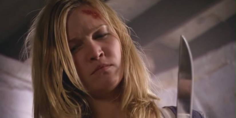 Julia Stiles as Lumen Pierce holding knife and looking downward in Dexter.