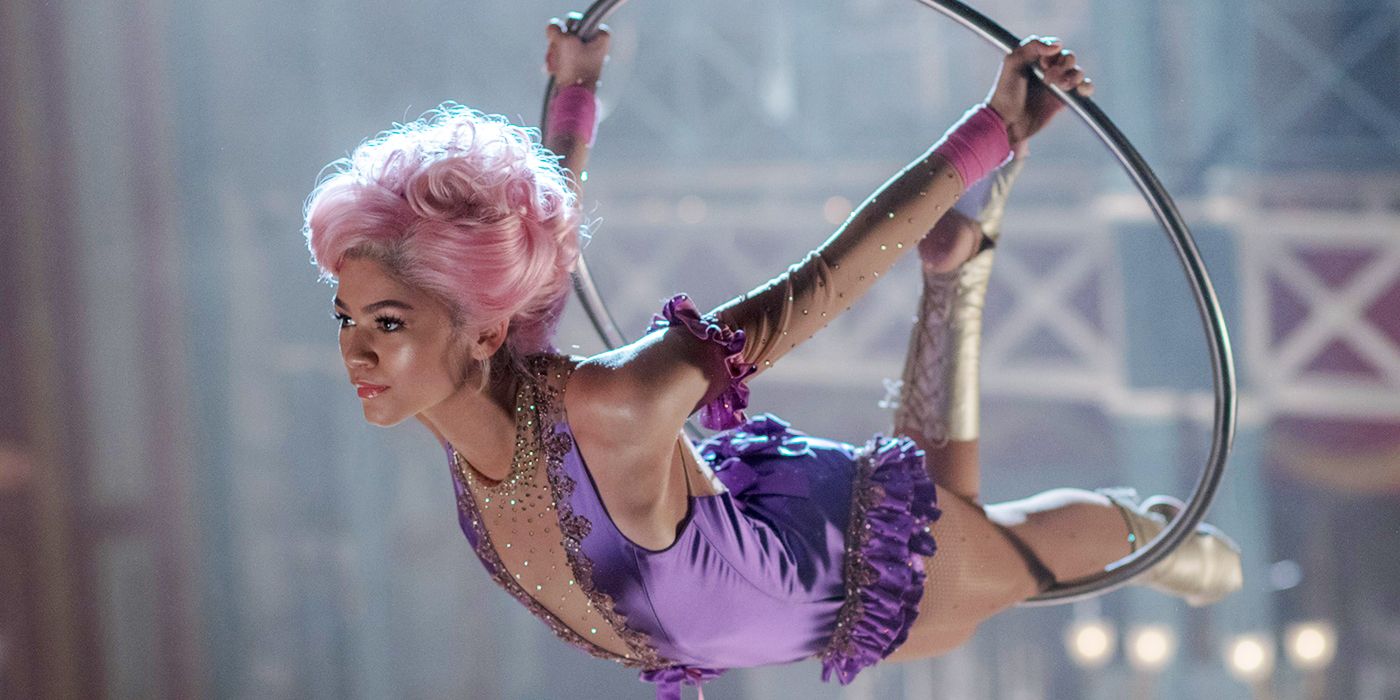 Anne Wheeler leaning through a circular trapeze in The Greatest Showman