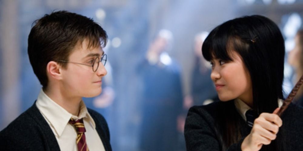 Harry and Cho Chang from Harry Potter smiling at each other in the Room of Requirement
