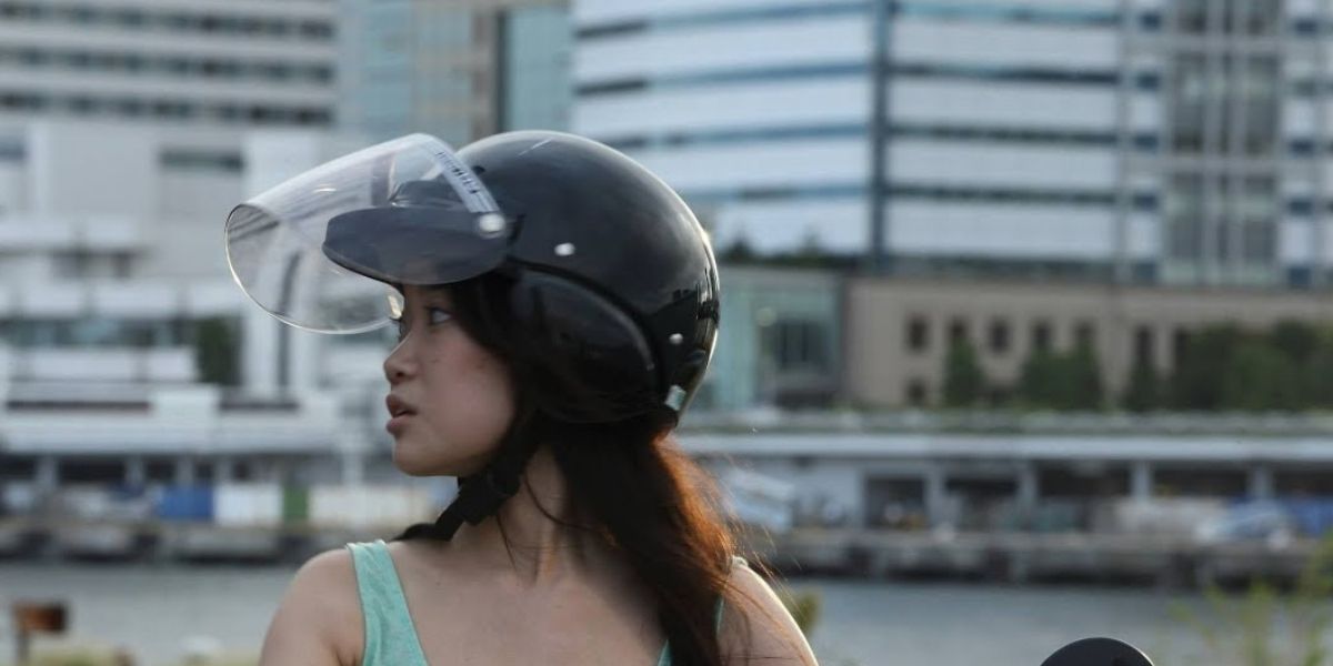 Haruka Abe's character driving a moped in Clean Bandit's 