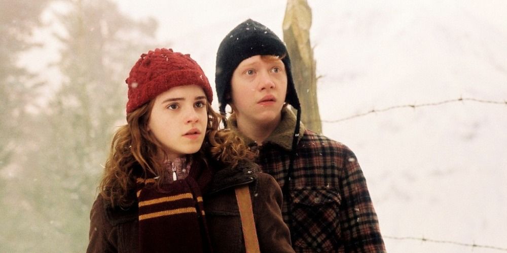 Hermione Granger and Ron Weasley from Harry Potter standing in winter attire in the snow