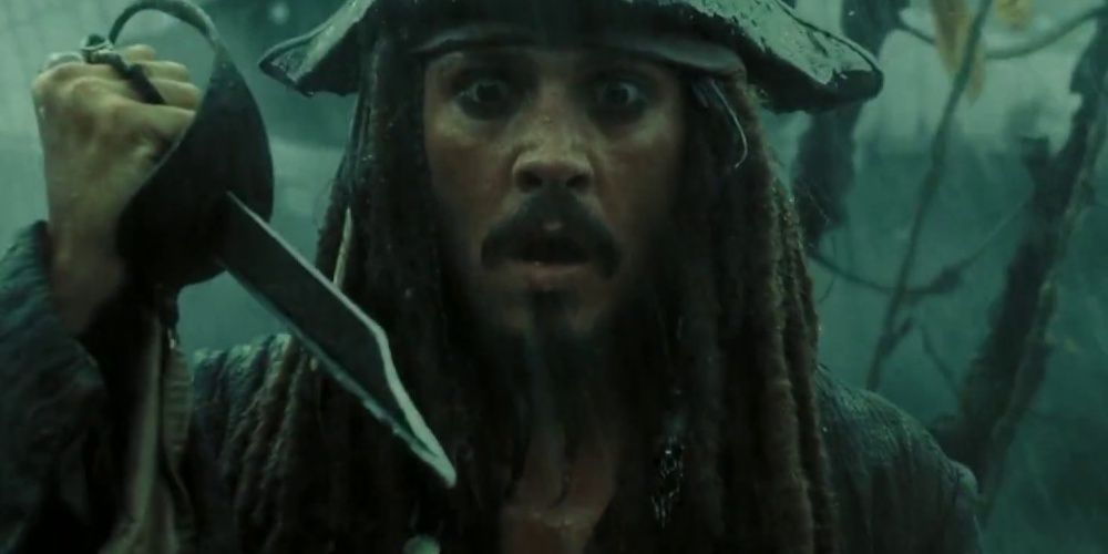 Jack Sparrow looking surprised while holding a broken sword in Pirates-of-the-Caribbean 3