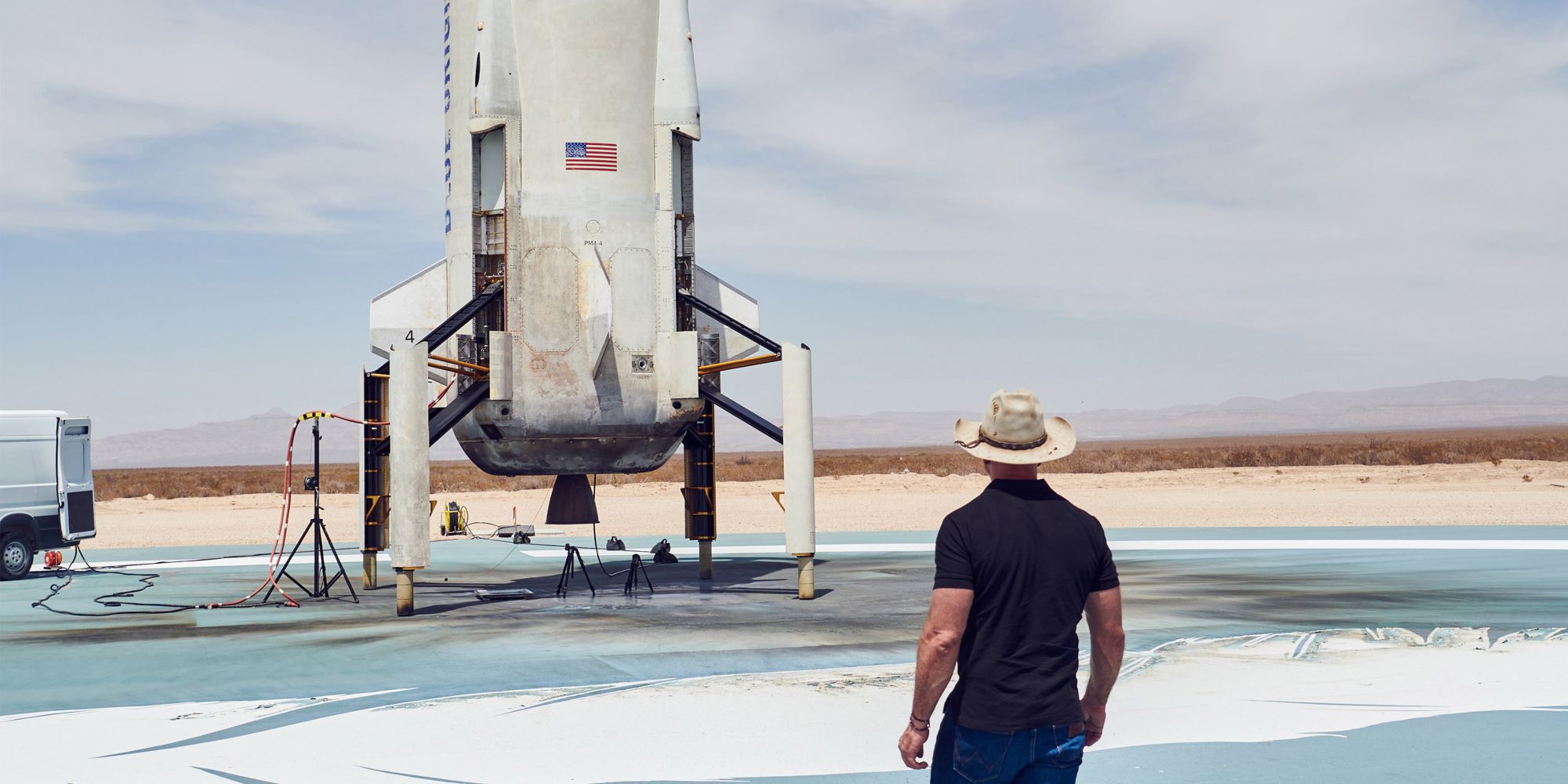 Jeff Bezos looking at Blue Origin rocket