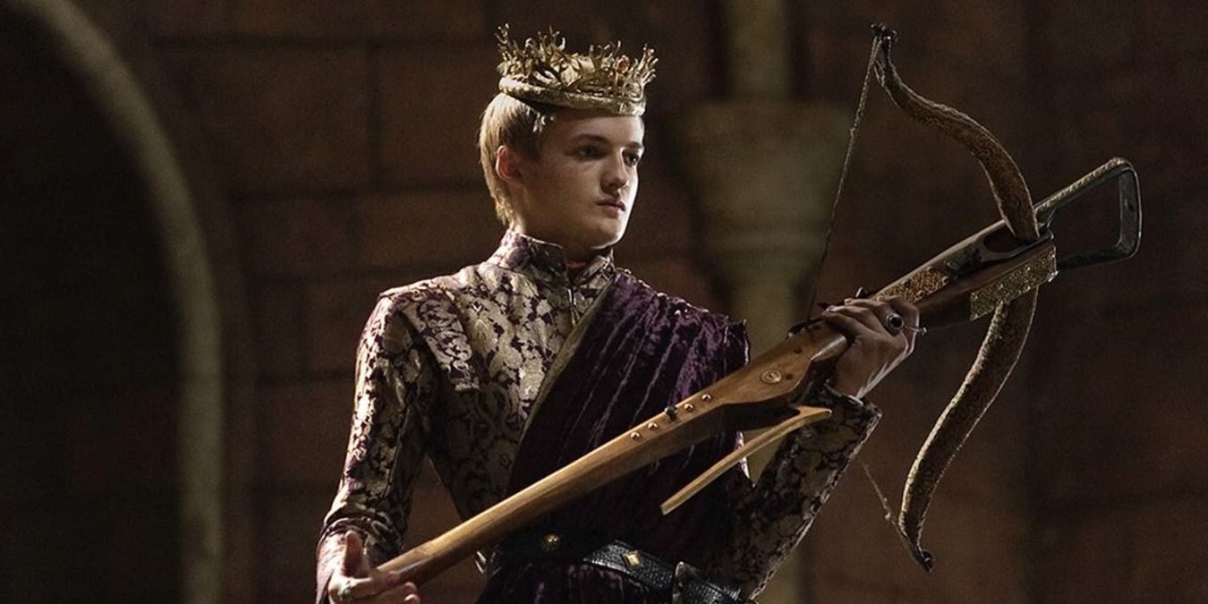 Joffrey wearing his crown and holding the cross bow in the throne room