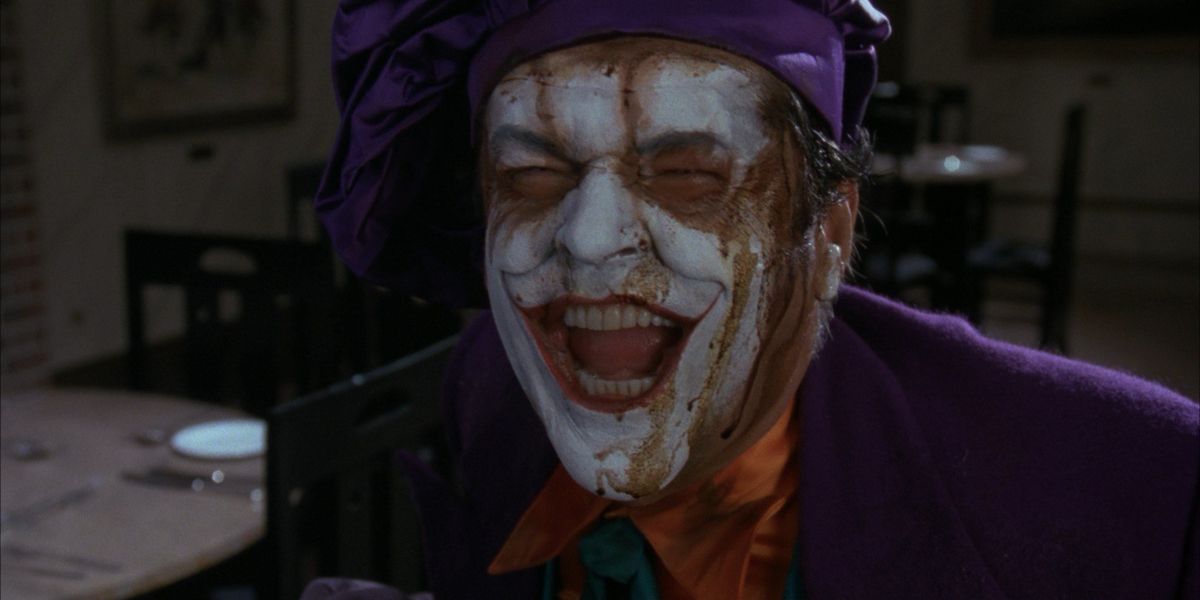 Joker laughing with face paint dripping in Batman 